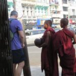 Yangon, Myanmar. I always give to the cloth because it feels good for me. I give monks credit for approaching a white guy but believe they see one brother with the universe versus a square-jawed American.